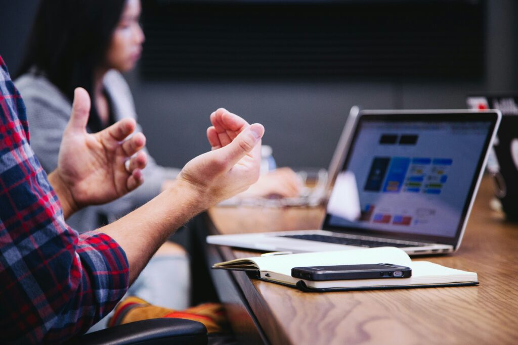 hands gesticulating while discussing the cost of digital marketing strategy vs a new website